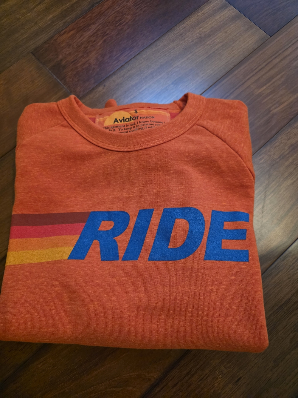 Aviator Nation Orange Crewneck Sweatshirt with Blue RIDE and Multicolor Stripes